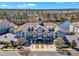 Aerial view of multi-story condominium buildings with garages and well-kept landscaping near a pond at 10421 Rosegate Ct # 303, Raleigh, NC 27617