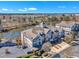 Aerial view showcasing multi-story condos with balconies overlooking a serene pond, surrounded by trees at 10421 Rosegate Ct # 303, Raleigh, NC 27617