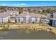 Beautiful aerial view of multi-story condos near a tranquil lake and lush green landscape, promising serene living at 10421 Rosegate Ct # 303, Raleigh, NC 27617