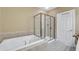 Bathroom featuring a soaking tub and tiled glass shower at 10421 Rosegate Ct # 303, Raleigh, NC 27617