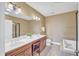 Luxurious bathroom with double vanity, soaking tub, tile floor, and separate glass-enclosed shower at 10421 Rosegate Ct # 303, Raleigh, NC 27617