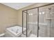 Bathroom showing soaking tub and tiled glass shower at 10421 Rosegate Ct # 303, Raleigh, NC 27617