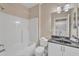 A full bathroom with a shower-tub combo, toilet, sink vanity with dark countertop and laundry closet at 10421 Rosegate Ct # 303, Raleigh, NC 27617