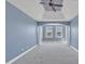 Large bedroom with a ceiling fan, gray carpet and blue walls with white decorative trim at 10421 Rosegate Ct # 303, Raleigh, NC 27617