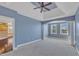 Bright, spacious bedroom features gray carpet, blue walls, large windows, and a decorative arched entryway at 10421 Rosegate Ct # 303, Raleigh, NC 27617