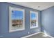 Bedroom with blue walls and a waterfront view from the large windows at 10421 Rosegate Ct # 303, Raleigh, NC 27617