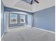 Spacious bedroom with blue walls, white trim, arched entryway, and windows letting in natural light at 10421 Rosegate Ct # 303, Raleigh, NC 27617