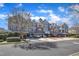 Condominiums with driveway, garages, lush trees and beautiful blue skies at 10421 Rosegate Ct # 303, Raleigh, NC 27617