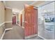 A carpeted hallway and garage featuring storage, shelving, and parking at 10421 Rosegate Ct # 303, Raleigh, NC 27617