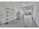 Spacious garage with bright white interior, shelving for storage, and open door showcasing the neighborhood at 10421 Rosegate Ct # 303, Raleigh, NC 27617