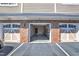 Private garages featuring brick accents and white doors on a sunny day, promising secure parking at 10421 Rosegate Ct # 303, Raleigh, NC 27617