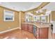 Well-lit kitchen featuring stainless steel appliances, granite counters, and hardwood floors at 10421 Rosegate Ct # 303, Raleigh, NC 27617
