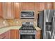 Kitchen close-up with stainless steel appliances and granite countertops at 10421 Rosegate Ct # 303, Raleigh, NC 27617