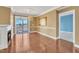 Bright living area with a cozy fireplace, hardwood floors, balcony access, and an adjacent room for flexible living options at 10421 Rosegate Ct # 303, Raleigh, NC 27617