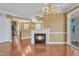 Open living area offers fireplace, chandelier, and access to kitchen and patio at 10421 Rosegate Ct # 303, Raleigh, NC 27617