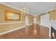 Inviting living room features hardwood floors, fireplace, and decorative chandelier at 10421 Rosegate Ct # 303, Raleigh, NC 27617