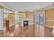 Cozy living space with fireplace, hardwood floors, balcony access, and open layout, ideal for entertaining and relaxation at 10421 Rosegate Ct # 303, Raleigh, NC 27617