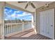 Covered patio boasts a ceiling fan and a serene lake view at 10421 Rosegate Ct # 303, Raleigh, NC 27617