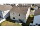 Aerial view of the home's backyard with a patio area, grill, and well-maintained lawn at 1055 Kerr St, Burlington, NC 27215