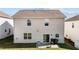Backyard featuring a small concrete patio, grass and the home's exterior with sliding door at 1055 Kerr St, Burlington, NC 27215