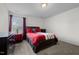 Cozy bedroom with a plush carpet, a comfortable bed, and dark furniture, offering a relaxing ambiance at 1055 Kerr St, Burlington, NC 27215
