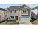 Charming two-story home featuring a front porch, attached garage, and neutral-toned siding at 1055 Kerr St, Burlington, NC 27215