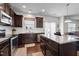 Kitchen featuring dark cabinets, granite countertops, and stainless steel appliances, perfect for cooking and dining at 1055 Kerr St, Burlington, NC 27215