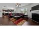 Open-concept living room with a cozy fireplace, leather sectional, and adjacent kitchen, creating an inviting atmosphere at 1055 Kerr St, Burlington, NC 27215