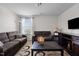 Cozy living room with plush seating, a large TV, and a stylish coffee table at 1055 Kerr St, Burlington, NC 27215