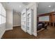 A partially-framed view of the bonus room featuring a custom bookcase and home theatre in the background at 1086 Tender Dr, Apex, NC 27502