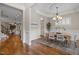 Refined dining area boasting hardwood floors, decorative chandelier, and seamless transition to the kitchen at 1086 Tender Dr, Apex, NC 27502
