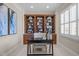 Well-lit home office featuring custom built-ins and a sleek black desk at 1086 Tender Dr, Apex, NC 27502