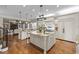 Spacious gourmet kitchen featuring dual islands, granite countertops, and stainless steel appliances at 1086 Tender Dr, Apex, NC 27502