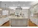 Bright and expansive kitchen with granite countertops, large center island, and custom cabinetry at 1086 Tender Dr, Apex, NC 27502