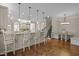 A beautifully designed kitchen with bar seating, granite countertops, stainless appliances, and hardwood floors at 1086 Tender Dr, Apex, NC 27502