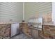 Outdoor kitchen featuring stainless steel grill and mini fridge at 1086 Tender Dr, Apex, NC 27502