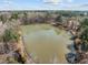Scenic aerial view of a large pond surrounded by lush greenery and mature trees at 1086 Tender Dr, Apex, NC 27502