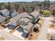 Aerial view of the property with detached garage, rear patio, and proximity to community pond at 1086 Tender Dr, Apex, NC 27502