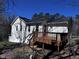The back of the home with a wooden deck and yard at 1104 Thelonious Dr, Raleigh, NC 27610