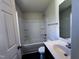 Bathroom features a white shower-tub combo, toilet, and single sink vanity at 1104 Thelonious Dr, Raleigh, NC 27610