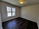 This bedroom features hard wood floors and a bright window letting in natural light at 1104 Thelonious Dr, Raleigh, NC 27610