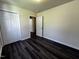 This bedroom features dark wood floors and a closet with ample storage opportunities at 1104 Thelonious Dr, Raleigh, NC 27610