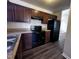 Efficient kitchen equipped with modern black appliances and wooden cabinets at 1104 Thelonious Dr, Raleigh, NC 27610
