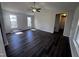Bright living room with high ceilings, ceiling fan, and modern dark wood flooring at 1104 Thelonious Dr, Raleigh, NC 27610