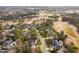 An aerial view of an upscale community with mature trees, a golf course, and a picturesque pond at 112 Trellingwood Dr, Morrisville, NC 27560