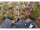 Aerial view showing a backyard oasis with a water feature, mature trees and playground at 112 Trellingwood Dr, Morrisville, NC 27560