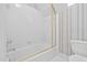 Cozy bathroom featuring a shower-tub combo with glass enclosure and tiled walls at 112 Trellingwood Dr, Morrisville, NC 27560