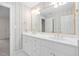 Bathroom featuring dual sinks, white cabinets and wallpaper design at 112 Trellingwood Dr, Morrisville, NC 27560