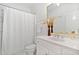 Bright white bathroom with a shower, toilet, sink, and a gold trimmed mirror at 112 Trellingwood Dr, Morrisville, NC 27560