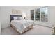 This bedroom features an abundance of natural light, neutral carpeting, and traditional decor at 112 Trellingwood Dr, Morrisville, NC 27560